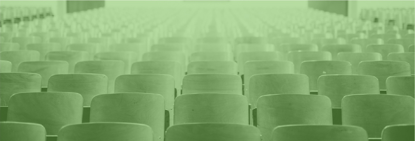 An empty university classroom, overlaid with a color filter of Duo green